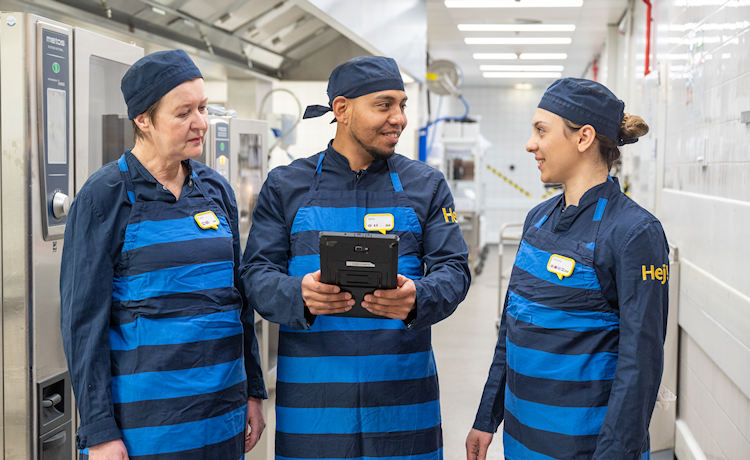 3 personen met blauw-zwart gestreepte shirts bij keukenapparatuur